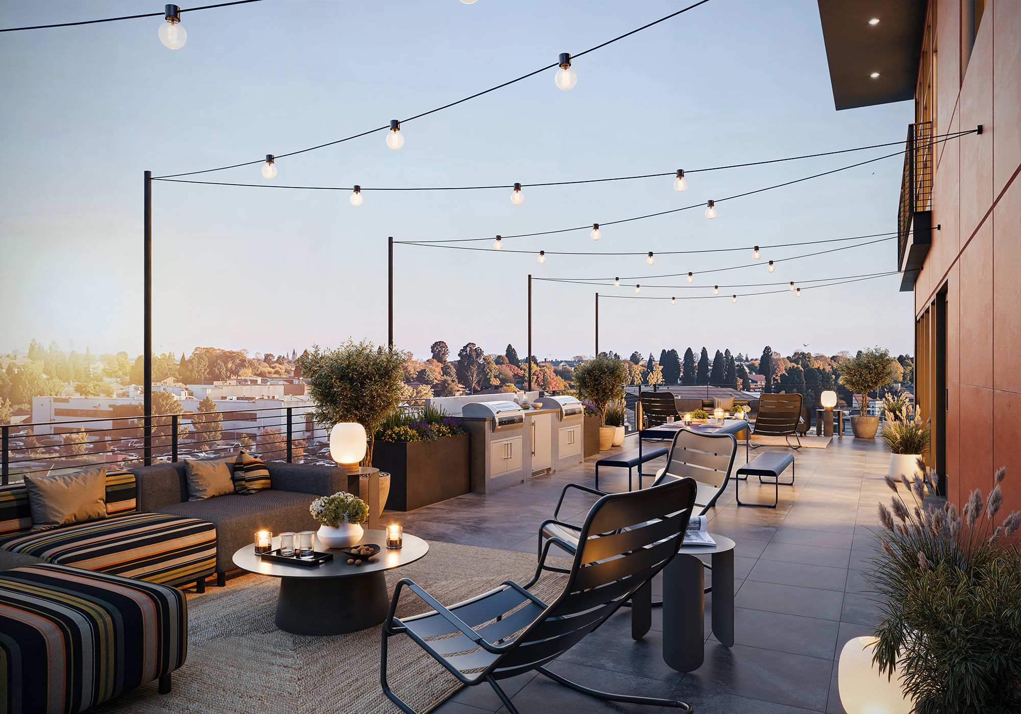Photo of a patio with bbq grills and seating with string lights hanging overhead
