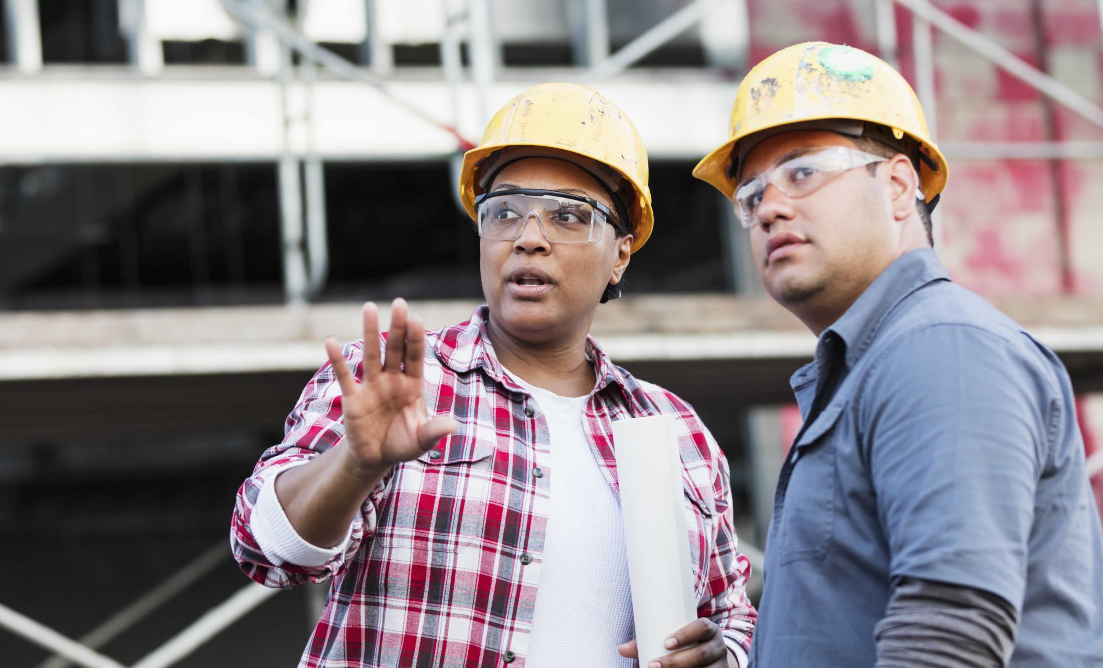 Woman and man stand at a construction site