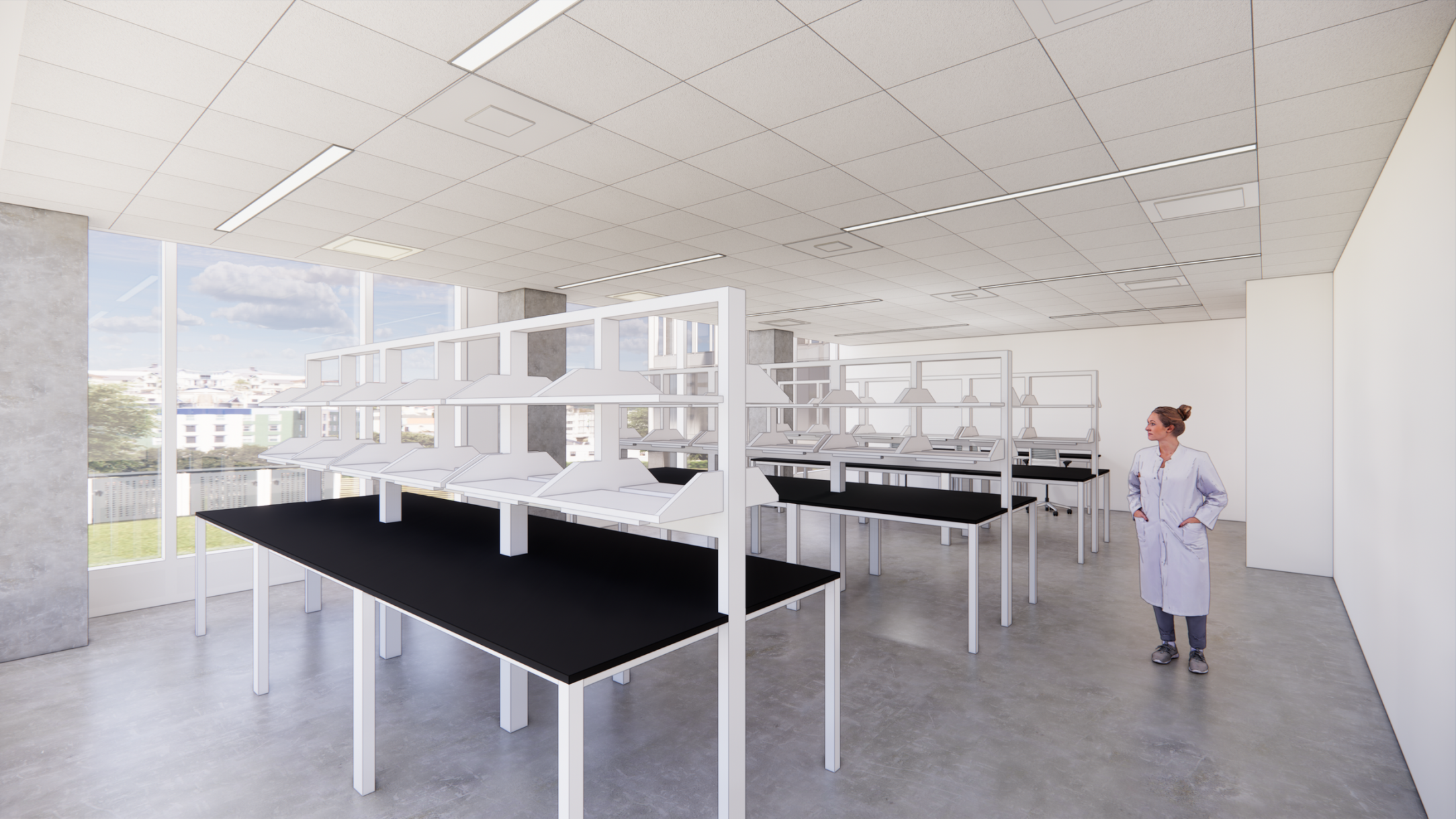 A science lab with white walls and black tables. A woman walks by the tables.