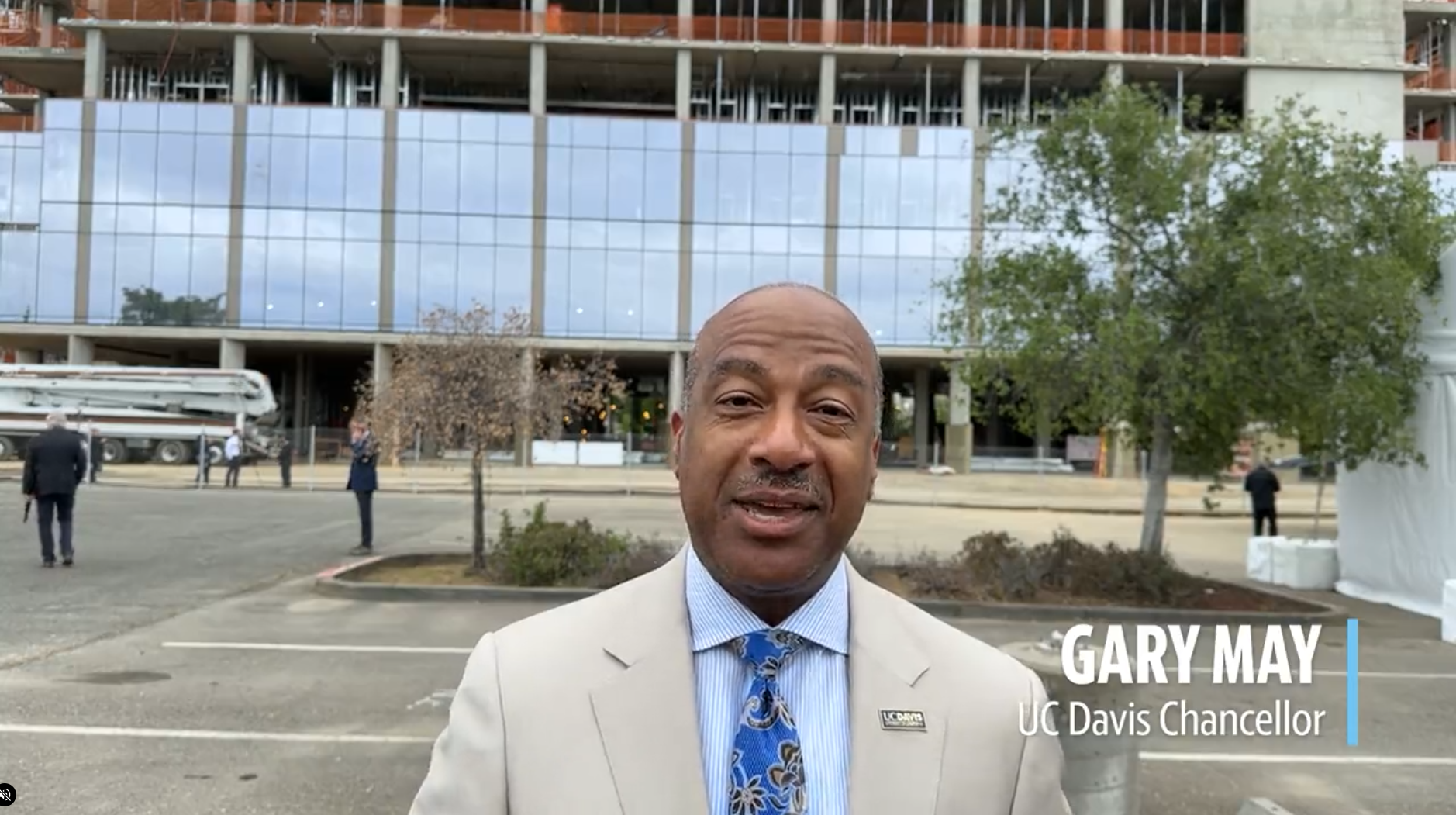 Screenshot of a video of Chancellor Gary May standing in front of Aggie Square construction.