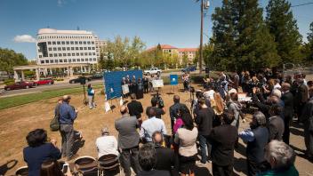 Crowd gathers in Oak Park for the Aggie Square announcement.
