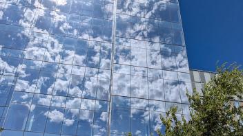 Building with glass that reflects the clouds in the sky