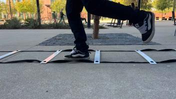 Close up shot of legs as a person jumps through ladders