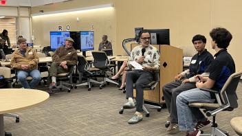 A group of people listening to presenters
