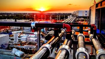 Photo of pipes with a sunrise in the background