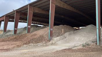 Different piles of clay under an awning