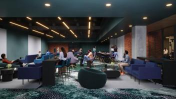 A large room with several chairs and tables where people socialize or study