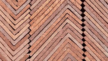 Thin L-shaped bricks stacked to create a geometric pattern