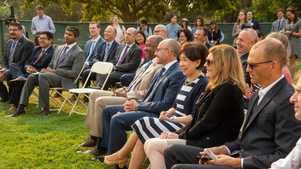 Speakers and community members gather to listen to the new Aggie Square announcement about the construction of the Rehabilitation Hospital.
