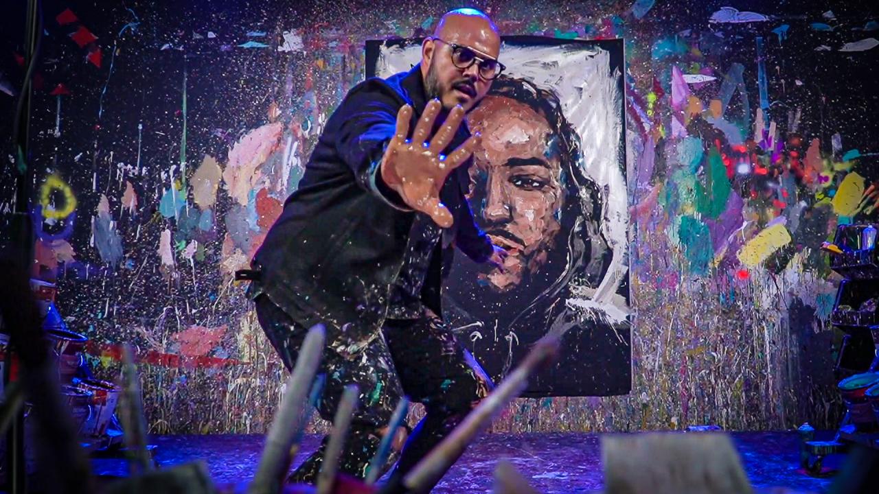 David Garibaldi holds his hand with wet paint toward the camera
