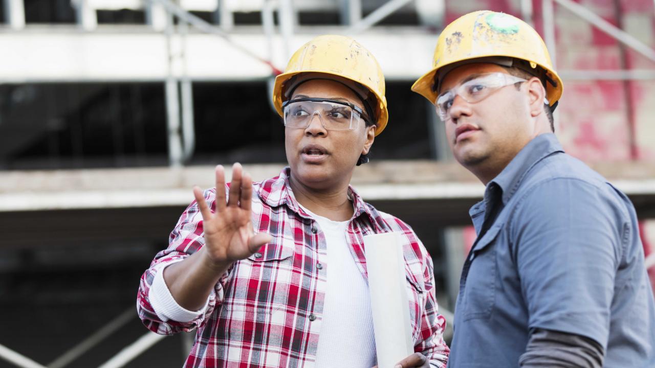 Woman and man stand at a construction site