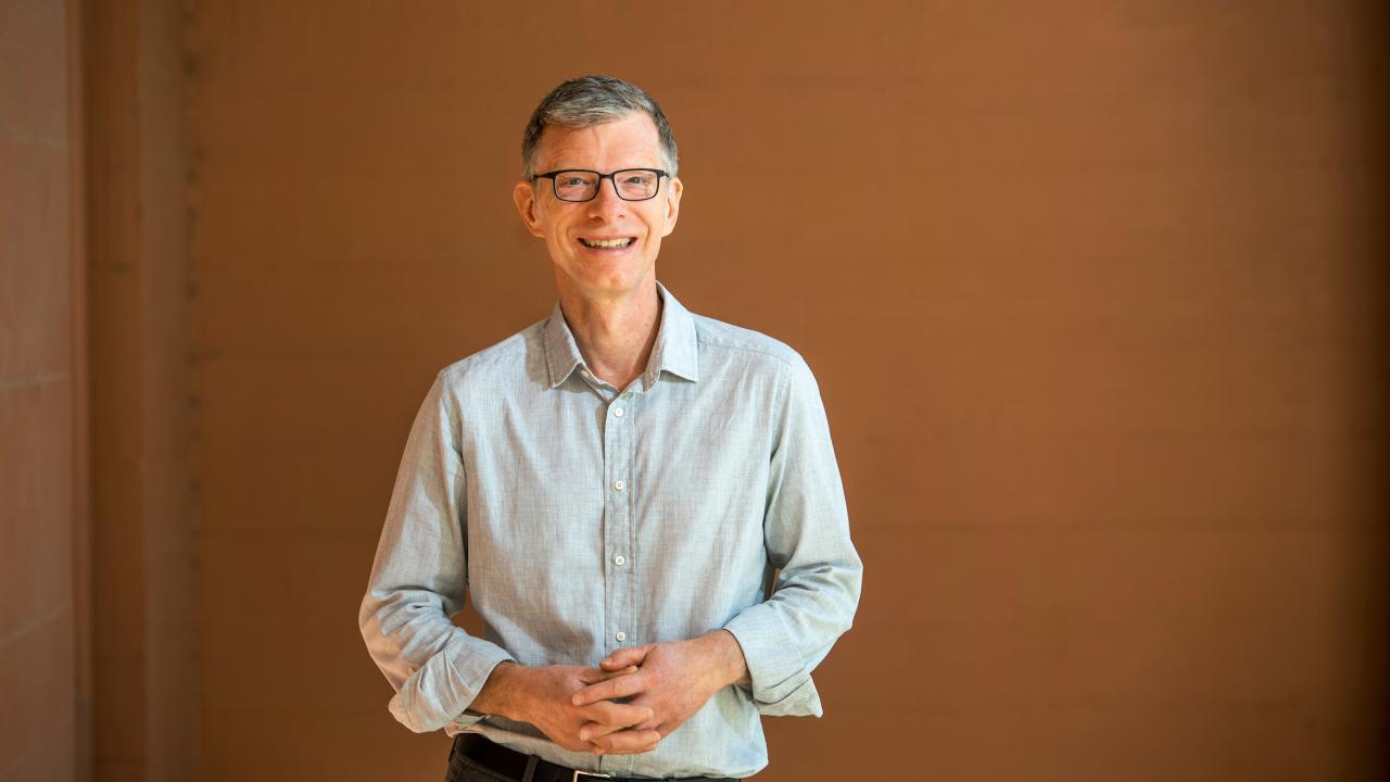John Marx smiling with hands clasped in front