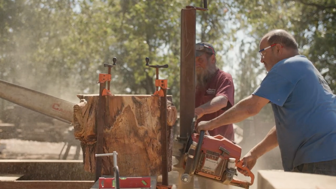 Mike Nelson, a custom woodworker, cutting wood using a saw