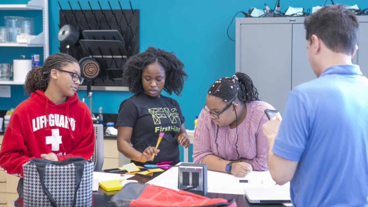 Middle school students work on a project