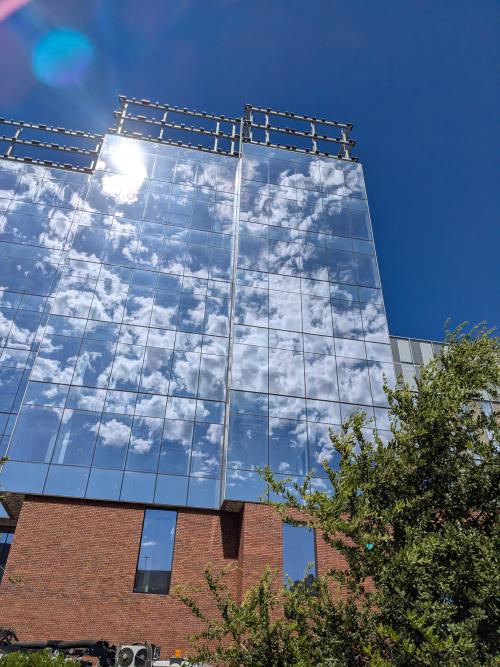 Building with glass that reflects the clouds in the sky