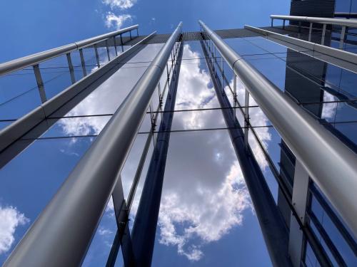 Photo of glass windows on a building, accented with pipes