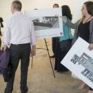 People gather around Aggie Square mockups