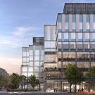 A rendering of a glass building with a sunset or dawn in the background