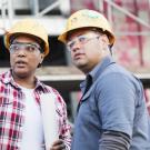Woman and man stand at a construction site