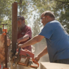 Mike Nelson, a custom woodworker, cutting wood using a saw