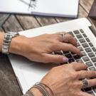 Close up of person typing on laptop