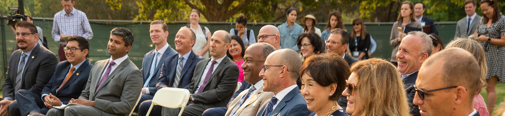 Speakers and community members gather to listen to the new Aggie Square announcement about the construction of the Rehabilitation Hospital.
